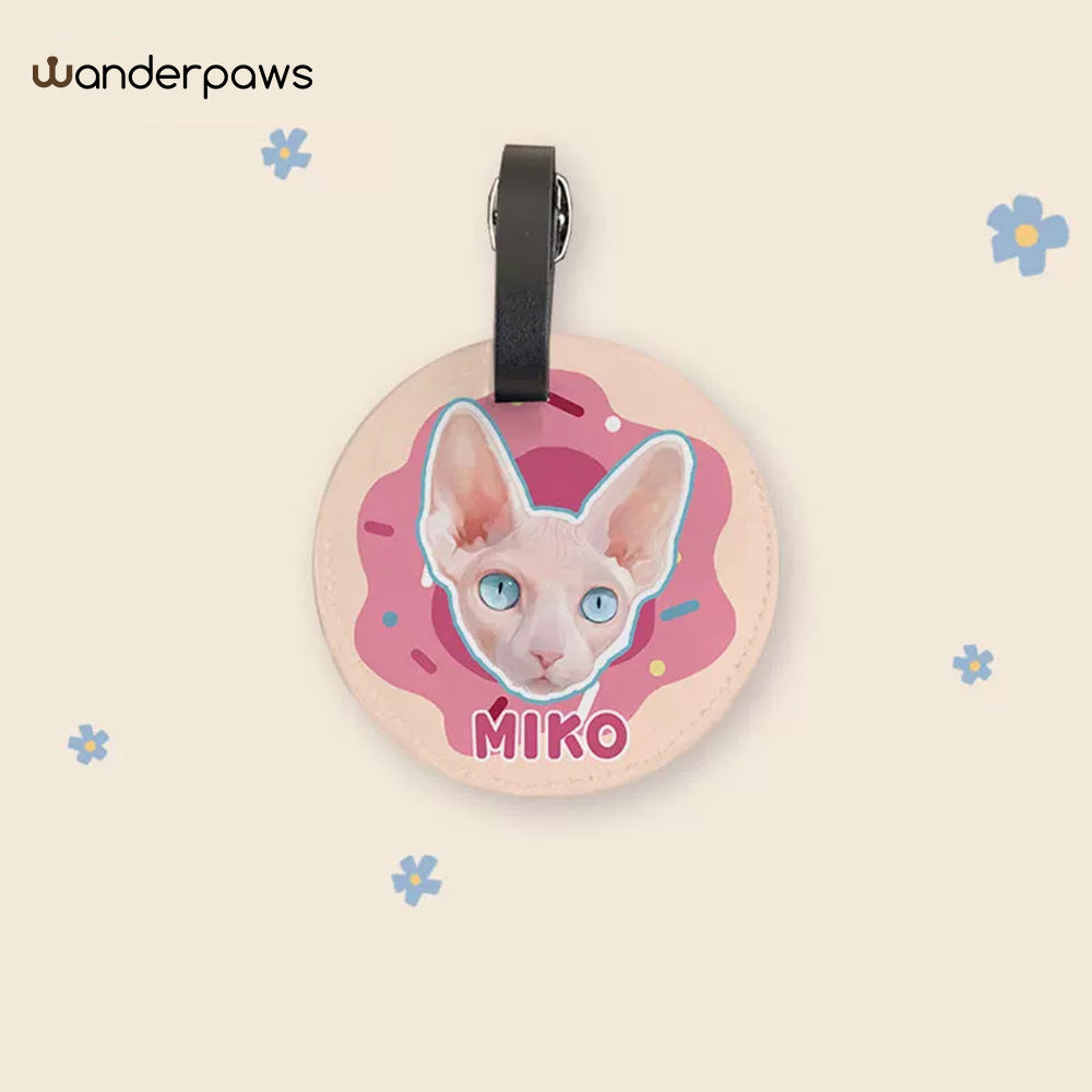 Pink donut-themed round personalized pet photo luggage tag featuring a blue-eyed Sphynx cat named Miko
