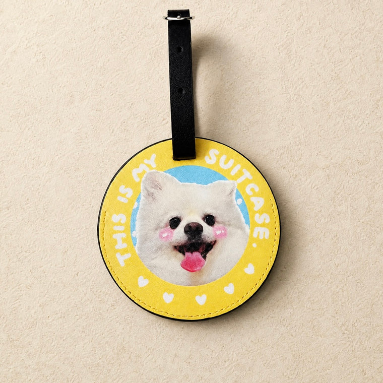 Dachshund wearing pink sunglasses beside a pink suitcase with a personalized pet photo luggage tag
