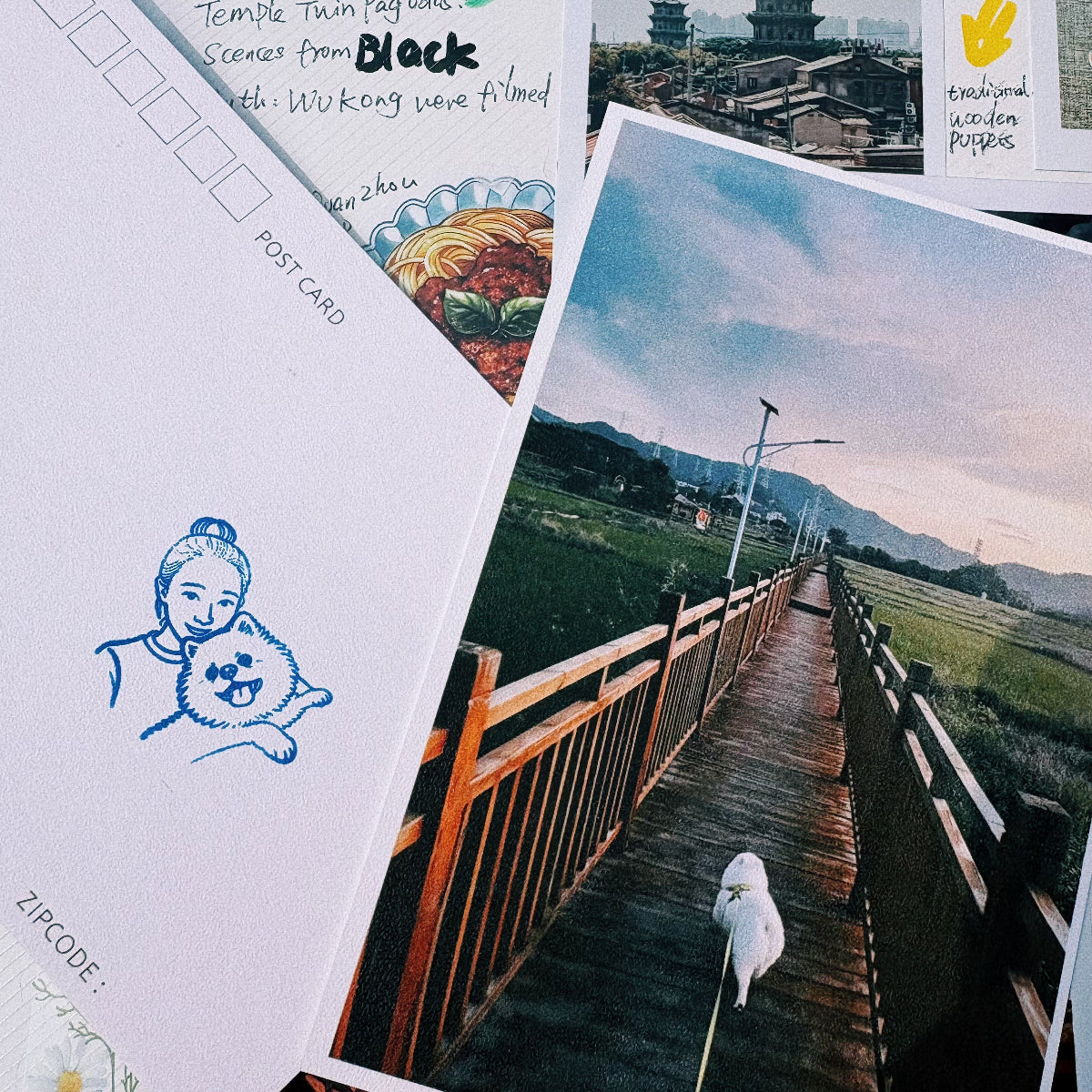 Blue personalized portrait stamp impression on a postcard beside a pet travel photo