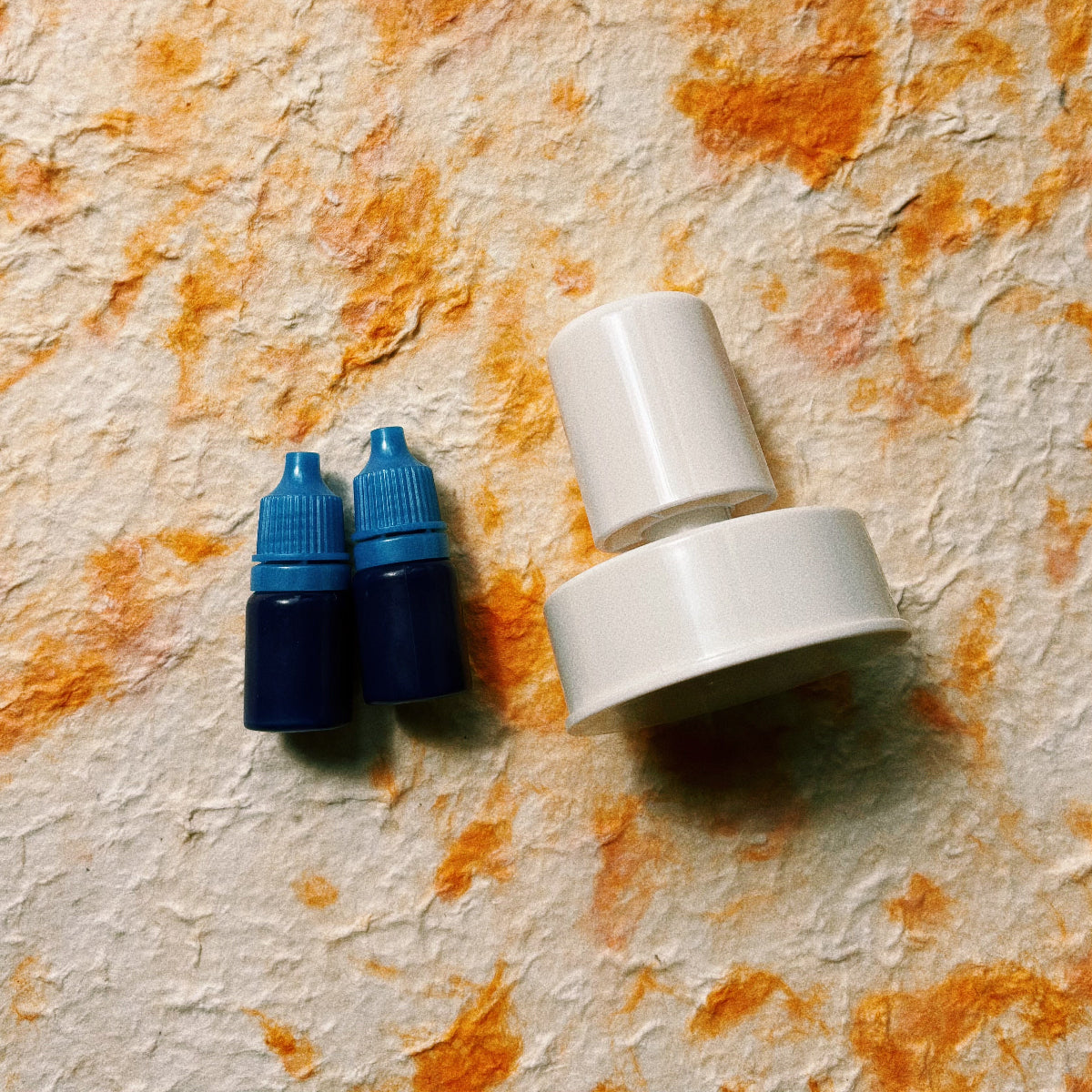 White personalized pet portrait stamp with two bottles of blue ink