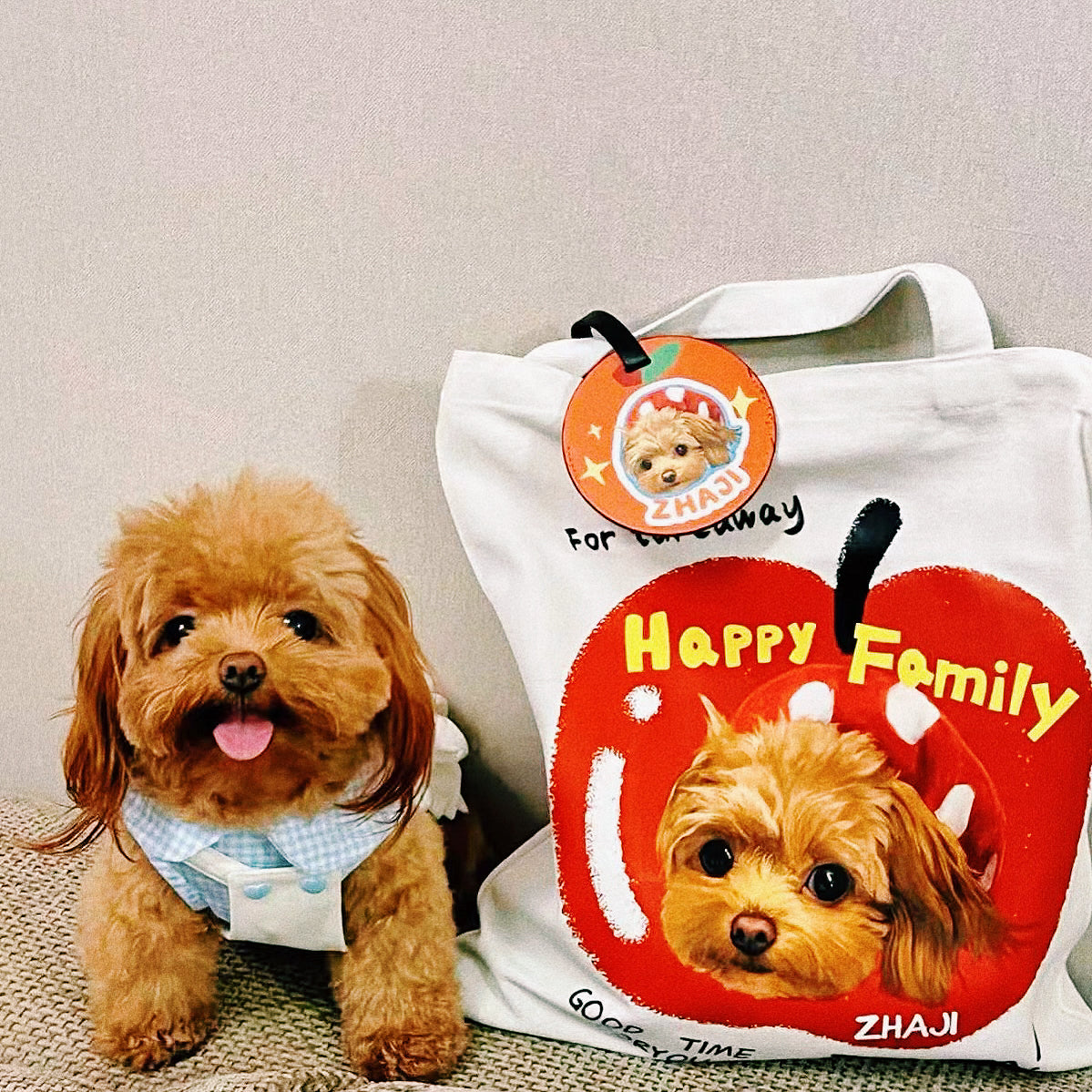 Brown poodle beside a personalized travel tote bag with an orange pet photo luggage tag attached
