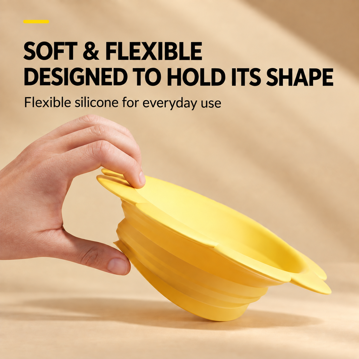 Hand folding a soft and flexible yellow silicone pet travel bowl
