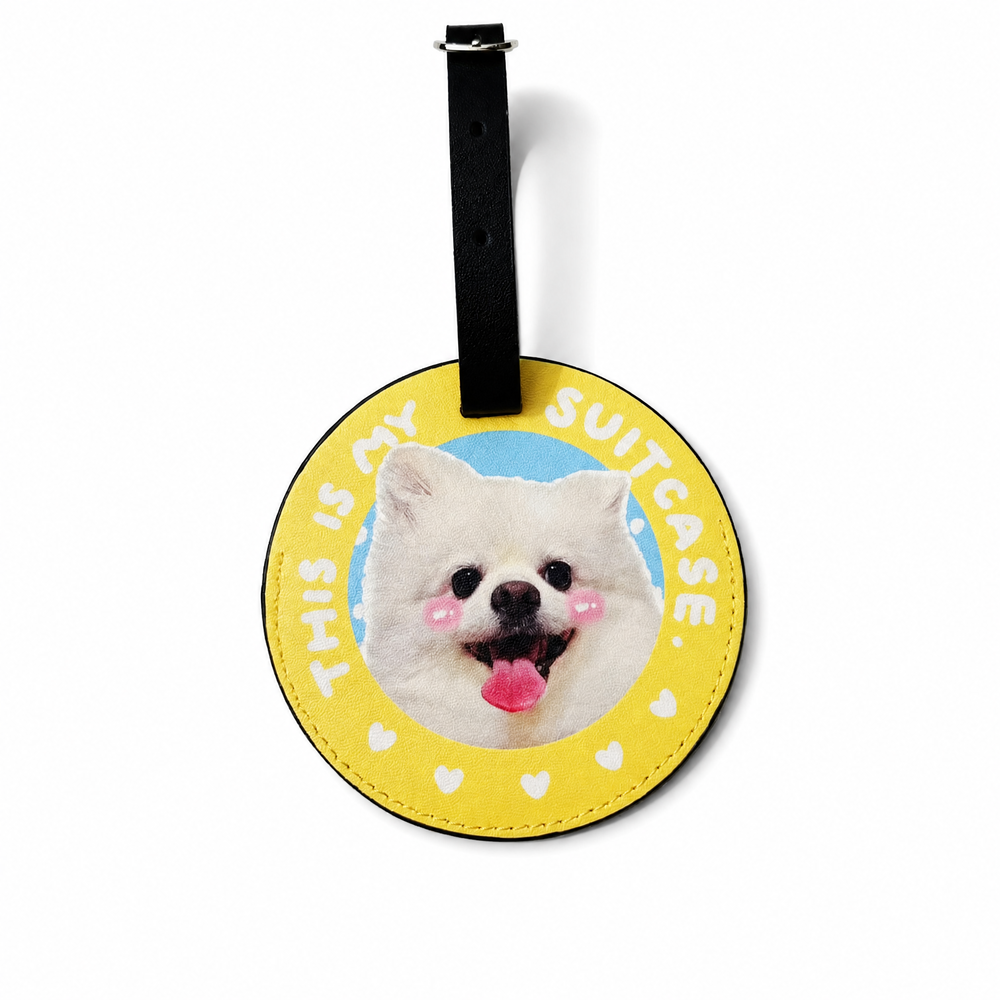 Yellow round personalized pet photo luggage tag featuring a white Pomeranian on a beige background